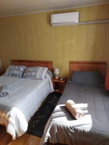 a bedroom with two beds and a bedskirts at Pratt 2 Valdivia in Valdivia