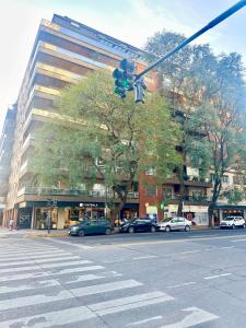 a traffic light with cars parked in front of a building at Terrazas del Puerto Suites in Buenos Aires