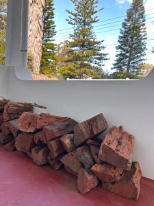 a pile of red rocks sitting next to a window at Beach Bungalow Henley - 4 minute walk to the Beach in Henley Beach +12 photos