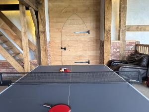 a ping pong table in a room with a ping pong ball at 1 Bed in Bickleigh 53296 in Cadeleigh +9 photos