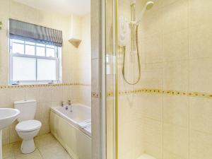 a bathroom with a shower and a toilet and a sink at 3 bed property in Overstrand KT178 in Overstrand +26 photos