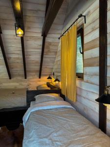 a bedroom with two beds in a log cabin at Villa Prive and Spa in Kopaonik +15 photos