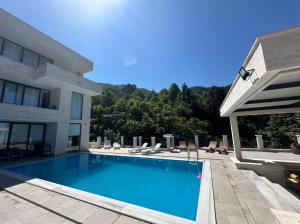 a swimming pool in front of a building at Villa Sunlight in Gonio