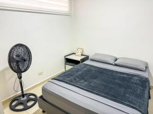 a bedroom with a bed and a fan at Apartamento Nuevo Central in Bucaramanga +26 photos