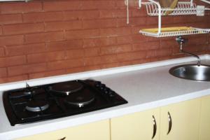 a kitchen counter with a stove and a sink at Apartments by the sea Milna, Vis - 3036 in Vis +26 photos