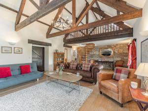 a living room with couches and a table at 3 Bed in Longhoughton 88231 in Long Houghton