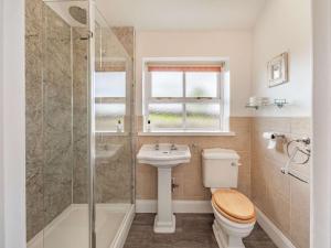 a bathroom with a toilet and a sink and a shower at 3 Bed in Longhoughton 88231 in Long Houghton +20 photos