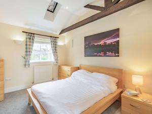 a bedroom with a large white bed and a window at 3 Bed in Longhoughton 88231 in Long Houghton