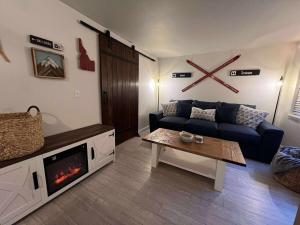 a living room with a blue couch and a fireplace at Powder and Paddle in McCall +3 photos