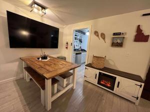 a living room with a table and a fireplace at Powder and Paddle in McCall