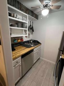 a kitchen with a sink and a ceiling fan at Powder and Paddle in McCall