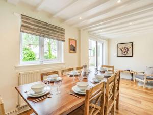 a dining room with a wooden table and chairs at 3 Bed in Portinscale SZ335 in Portinscale