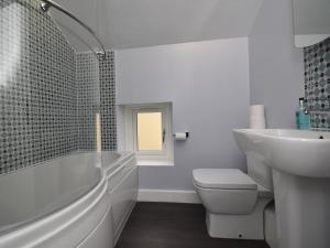 a bathroom with a white tub and a sink and a toilet at 2 Bed in Glenridding SZ178 in Glenridding +6 photos