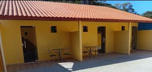 a yellow building with tables and chairs in it at Pousada Araújo em Paraty 1 in Paraty