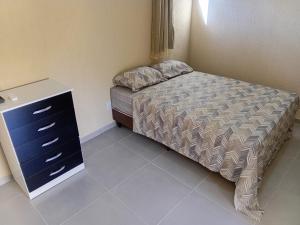 a small bedroom with a bed and a dresser at Pousada Araújo em Paraty 1 in Paraty