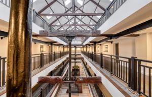an empty hallway of an old building with a metal roof at Stay at 52 The Maltings, Burton on Trent - Modern One Bedroom Apartment in Burton upon Trent