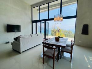 a living room with a table and a white couch at Casa Verapaz in Santa Catarina Palopó +57 photos