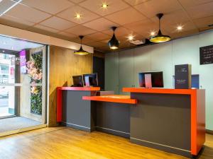 un ufficio con due scrivanie con monitor sopra di ibis Paris Gare du Nord La Fayette a Parigi