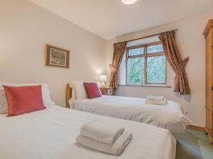 two beds in a room with a window at 3 Bed in Water Yeat SZ079 in High Nibthwaite