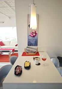 a table with two plates of food and a glass of wine at Modern Panoramic Villa with Pool & Terrace in Puerto de la Cruz +19 photos