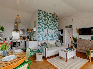 a living room with a couch and a table at 2 Bed in Whitsand Bay 91328 in Antony