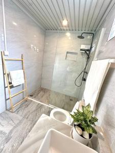 a bathroom with a shower and a toilet and a plant at Haidens Cabin in Locsin +21 photos
