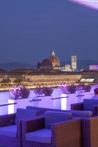 a view of a building with blue chairs and a building at Mh Florence Hotel & Spa in Florence
