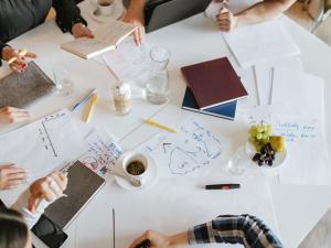 a group of people sitting around a table with papers at ibis Epinal Centre in Épinal