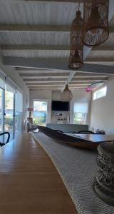 a living room with a large boat on the floor at Casa de Flia in Villa Gesell