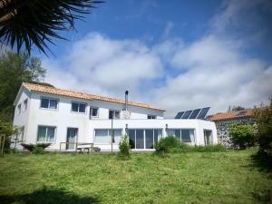 a white house with solar panels on the roof at Quarto Limao Casa citrina in Lajes das Flores