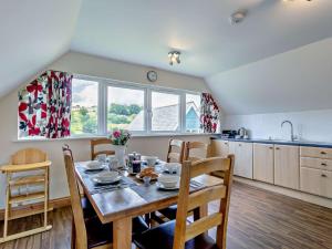 a kitchen with a wooden table with chairs and a dining room at 3 Bed in Crediton WAIE2 in Zeal Monachorum