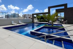 a swimming pool on the roof of a building at Apto 2/4 com AR a 7min da Praia de Aruana in Santa Maria