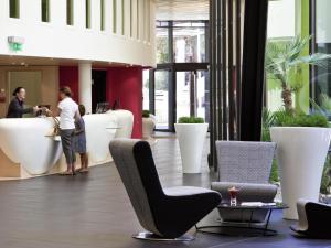 a lobby with chairs and people in a building at Novotel Marseille Vieux Port in Marseille +96 photos