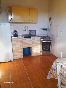 a kitchen with a refrigerator and a counter top at Apartamento com 2 quartos suítes em Tramandaí in Tramandaí