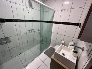 a bathroom with a glass shower and a sink at Casa Alto da Glória in Curitiba +7 photos
