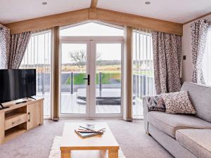 a living room with a couch and a large window at 2 Bed in St Andrews 90764 in St. Andrews