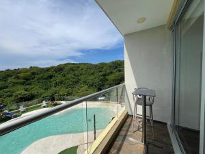 a balcony with a view of a swimming pool at Hotel Explore Caño Dulce in Tubará
