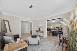 a living room with a couch and a table at Spacious Family Home BBQ and Outdoor Area in Shoreacres +43 photos