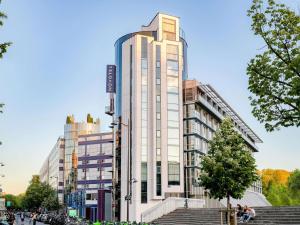 a tall white building with stairs in front of it at Novotel Paris Centre Bercy in Paris