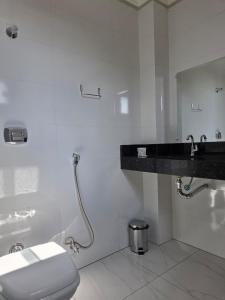 a bathroom with a toilet and a sink and a tub at Ello Hotel Cristalina in Cristalina +111 photos