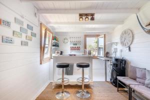 a kitchen and living room in a tiny house at Old Cottage The Log Cabin in Bacton