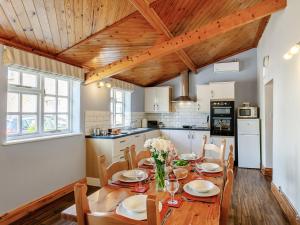 a kitchen and dining room with a wooden table and chairs at 3 Bed in Crediton WAIEC in Zeal Monachorum