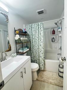 a bathroom with a toilet and a shower curtain at Dream room in Moncton +26 photos