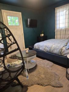 a bedroom with a bed and a chair and a table at Dream room in Moncton +26 photos