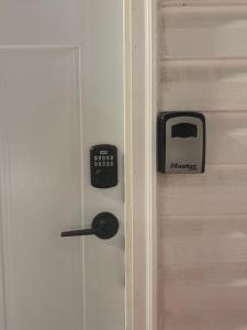 a door with a clock and a toaster on it at Dream room in Moncton