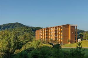 a large building on top of a hill with trees at Hilton Vacation Club MountainLoft Gatlinburg in Gatlinburg