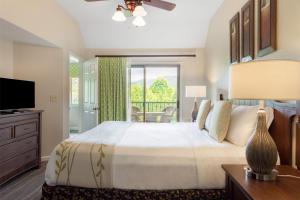 a bedroom with a large bed and a balcony at Hilton Vacation Club MountainLoft Gatlinburg in Gatlinburg