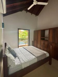 a bedroom with a large bed and a window at Alma del paraíso en la playa in Las Terrenas +43 photos