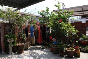 a garden with a bunch of potted plants and clothes at Project Uchi SS2 in Petaling Jaya