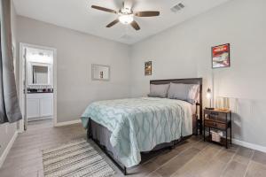 a bedroom with a bed and a ceiling fan at Modern Escape in Cedar Creek in Cedar Creek